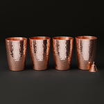 Set of four copper water cups with a small copper mantra bell