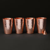 Set of four copper water cups with a small copper mantra bell