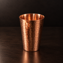 10 ounce hand-hammered Just Right copper cup on a dark background