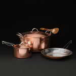 Essential copper cookware set: Dutch oven and saucepan with lids, a 10 inch skillet, and a wooden spoon